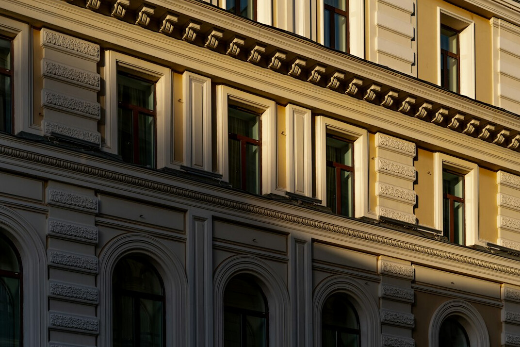 Fassade eines klassischen europäischen Bildungsgebäudes im Morgenlicht